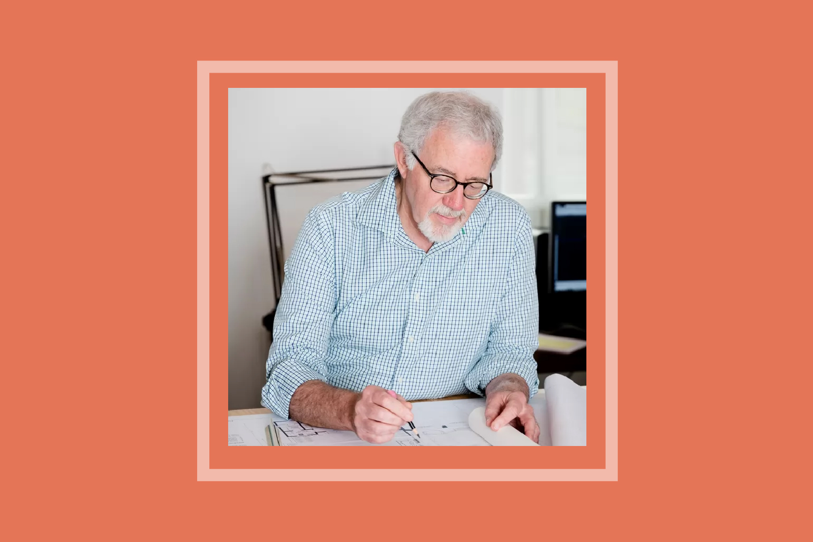 image of older man with glasses sitting in a desk chair drawing
