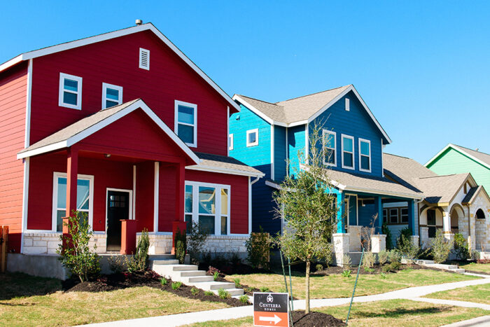 streetscape of a red and blue house and bright blue sky