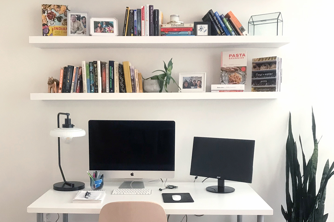 White office and desk with books and plants